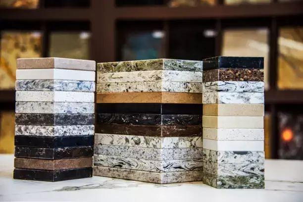 A display of natural stone countertop samples, showcasing a variety of colors and textures, including granite, marble, and quartz options, ideal for kitchen and bathroom renovations.