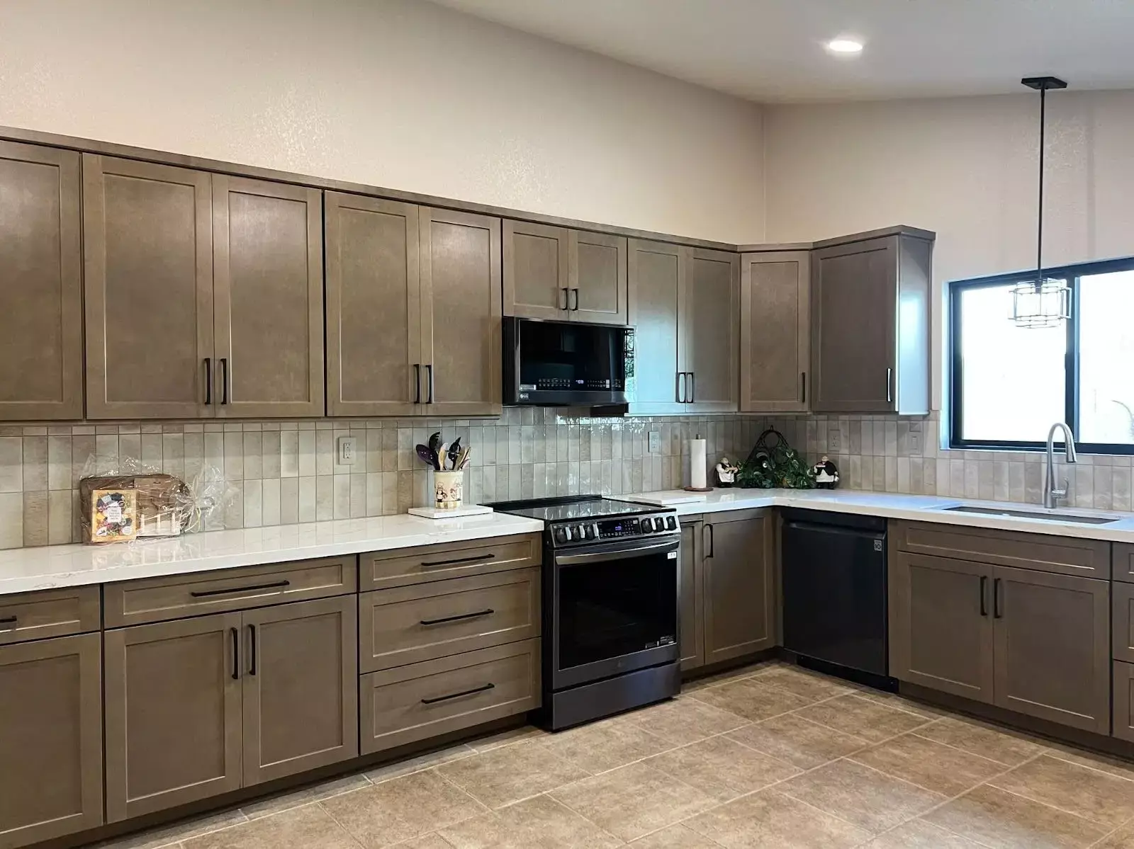 Budget-friendly kitchen remodel featuring neutral-tone cabinets, stainless steel appliances, and a tiled backsplash that blends style and savings.