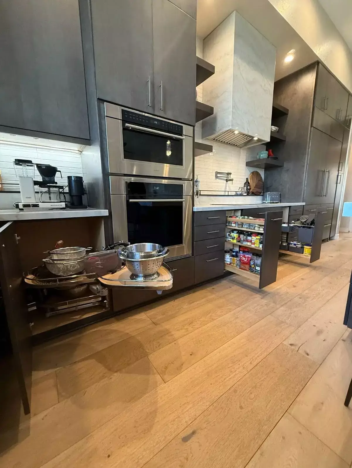 Modern kitchen with clever pull-out shelves and swing-out cabinets showcasing efficient small space storage solutions.